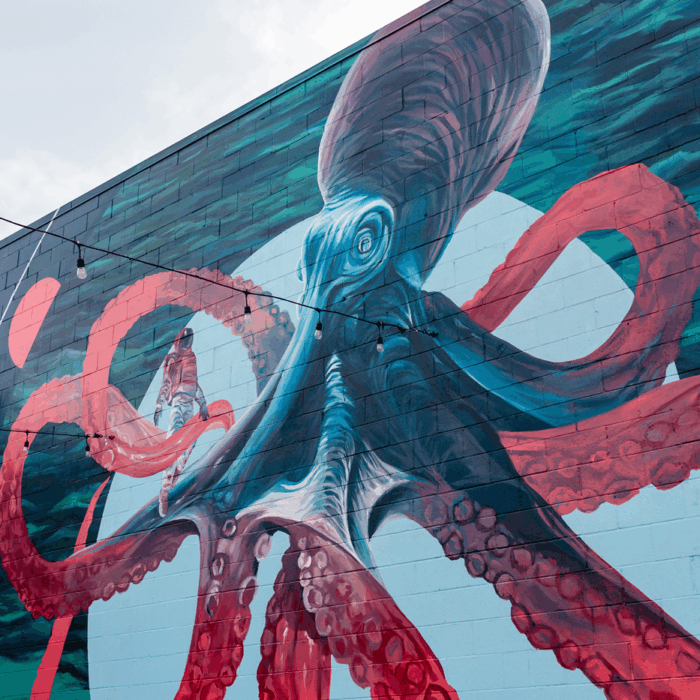 A mural of an octopus an an astronaut.