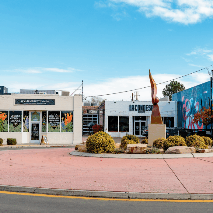 The exterior storefronts of two buildings next to one another, Wyld Market Collective and La Condesa Eatery.