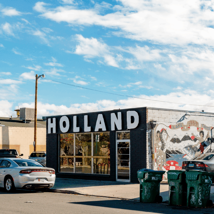 The exterior of a black building, The Holland Project a venue space for art and live music.